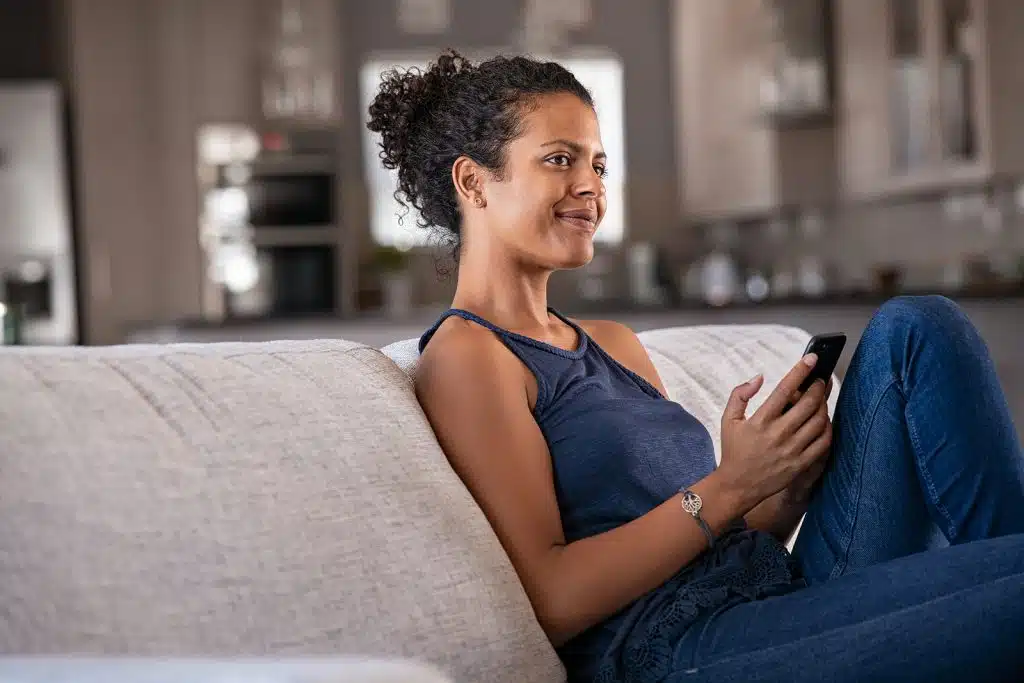 Woman having a virtual therapy session from her couch